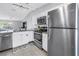 Modern kitchen featuring stainless steel appliances, white cabinets, and an open layout at 4116 43Rd W Ave, Bradenton, FL 34205