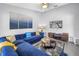 Bright living room featuring a large blue sectional sofa, modern TV, and stylish decor for a comfortable and inviting space at 4116 43Rd W Ave, Bradenton, FL 34205