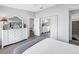 Serene bedroom with white dresser and TV, with mirrored closet doors reflecting a view into the adjacent dining room at 4116 43Rd W Ave, Bradenton, FL 34205