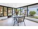 Enclosed patio with a glass table and seating, providing a relaxing outdoor dining or lounge area with natural light at 4116 43Rd W Ave, Bradenton, FL 34205