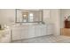 Bright bathroom featuring dual sinks and large mirror reflecting tub and shower at 4137 Woodview Dr, Sarasota, FL 34232