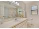 Bathroom features a sink, toilet, shower and tub combo with colorful curtain and vanity with lighting at 4137 Woodview Dr, Sarasota, FL 34232
