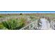 Beautiful beach access featuring tropical foliage and sandy path at 4137 Woodview Dr, Sarasota, FL 34232
