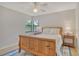 Bedroom features a wood bed frame, side tables with lamps, a ceiling fan, and natural light from the window at 4137 Woodview Dr, Sarasota, FL 34232