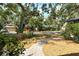Landscaped front yard with a stone pathway leading to the street at 4137 Woodview Dr, Sarasota, FL 34232