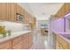 Functional kitchen area with wood cabinets, white appliances, tile floor and breakfast table at 4137 Woodview Dr, Sarasota, FL 34232