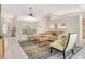 Cozy living area with stylish furniture, tile flooring, and a ceiling fan, and view into the dining area at 4137 Woodview Dr, Sarasota, FL 34232