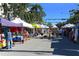 Outdoor street market featuring a variety of vendors and shoppers at 4137 Woodview Dr, Sarasota, FL 34232