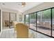 Bright sunroom with sliding glass doors, tile floor, and a cozy chair for relaxation with backyard view at 4137 Woodview Dr, Sarasota, FL 34232