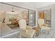Bright sunroom features tile flooring, two chairs, and sliding glass doors leading to the interior of the home at 4137 Woodview Dr, Sarasota, FL 34232