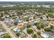 Aerial view showcases a well-maintained neighborhood with mature trees and easy access to the highway and local pond at 4222 Lanai Dr, Sarasota, FL 34241