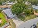 Aerial view of a well-maintained property with a large tree in the front yard and a long driveway at 4222 Lanai Dr, Sarasota, FL 34241