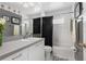 Bathroom with a white sink, toilet, bathtub, and dark grey walls featuring floral decor at 4222 Lanai Dr, Sarasota, FL 34241