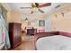 Bright bedroom featuring wood floors, a ceiling fan, a closet with mirrored doors and large dresser at 4222 Lanai Dr, Sarasota, FL 34241