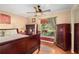 Comfortable bedroom featuring wood floors, a ceiling fan, and a large window offering plenty of natural light at 4222 Lanai Dr, Sarasota, FL 34241