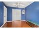 Bedroom with a ceiling fan, hardwood floors, and a closet with white double doors at 4222 Lanai Dr, Sarasota, FL 34241