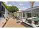 View of the home's exterior with RV parking, utility area, and screened-in lanai with a pool at 4222 Lanai Dr, Sarasota, FL 34241