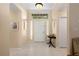 Bright foyer featuring tile flooring, transom window, sidelights, decorative lighting, and neutral wall paint at 4222 Lanai Dr, Sarasota, FL 34241