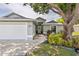 Inviting home with a two-car garage, lush lawn, and attractive landscaping surrounding the front entrance at 4222 Lanai Dr, Sarasota, FL 34241