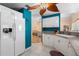 The kitchen features white cabinets, stainless steel appliances and access to the living room at 4222 Lanai Dr, Sarasota, FL 34241