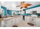 Spacious kitchen boasting white cabinetry, tile flooring, eat-in breakfast nook, and ample counter space at 4222 Lanai Dr, Sarasota, FL 34241