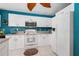Bright kitchen features white cabinets, stainless steel appliances, and blue accent wall at 4222 Lanai Dr, Sarasota, FL 34241