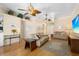 Open-concept living room featuring wood floors, neutral paint, ceiling fans, and ample natural light at 4222 Lanai Dr, Sarasota, FL 34241