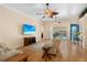 Comfortable living room with hardwood floors, ceiling fans, light-colored furniture, and a view of the backyard pool at 4222 Lanai Dr, Sarasota, FL 34241