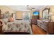 Bedroom with a queen size bed, dresser, TV and a view of the pool through the window at 4222 Lanai Dr, Sarasota, FL 34241