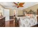 Bedroom features a large bed, wood floors, and a ceiling fan at 4222 Lanai Dr, Sarasota, FL 34241