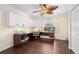 Spacious office space featuring hardwood floors, white cabinets and a ceiling fan at 4222 Lanai Dr, Sarasota, FL 34241