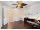 Office space featuring hardwood floors, white cabinets, modern desk and ceiling fan at 4222 Lanai Dr, Sarasota, FL 34241