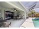 Screened-in patio with a beautiful pool, tables and chairs for enjoying outdoor living at 4222 Lanai Dr, Sarasota, FL 34241