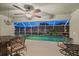 Evening view of the screened-in pool and spa with stylish lighting and comfortable patio furniture at 4222 Lanai Dr, Sarasota, FL 34241