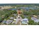 Aerial view showcasing the home's location near a golf course, lakes, and lush greenery at 435 Whispering Oaks Ct, Sarasota, FL 34232