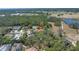 Aerial view of the property highlighting the proximity to a golf course and other neighborhood homes at 435 Whispering Oaks Ct, Sarasota, FL 34232