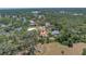 Aerial view of property situated in a lush, wooded neighborhood with easy access to local amenities at 435 Whispering Oaks Ct, Sarasota, FL 34232