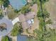 Aerial view of the home showcasing the backyard patio and surrounding landscaping at 435 Whispering Oaks Ct, Sarasota, FL 34232
