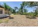 Spacious backyard with mature trees and a patio, perfect for outdoor living at 435 Whispering Oaks Ct, Sarasota, FL 34232