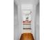Hallway view of bathroom with wood floors and accent countertop at 435 Whispering Oaks Ct, Sarasota, FL 34232