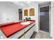 Bright bathroom featuring a glass-enclosed shower, accent countertop, and tiled floors at 435 Whispering Oaks Ct, Sarasota, FL 34232