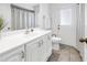 Bathroom featuring white vanity, tile floors, and a door leading to the backyard at 435 Whispering Oaks Ct, Sarasota, FL 34232