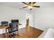 Bright bedroom features a ceiling fan, a desk, and wood-look floors at 435 Whispering Oaks Ct, Sarasota, FL 34232