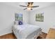 Bedroom with wood-look flooring and windows providing plenty of natural light at 435 Whispering Oaks Ct, Sarasota, FL 34232