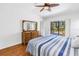 Bedroom with hardwood floors and slider to patio at 435 Whispering Oaks Ct, Sarasota, FL 34232