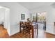 Dining area with hardwood floors and seating for four, with sliding glass doors leading to an outdoor patio at 435 Whispering Oaks Ct, Sarasota, FL 34232