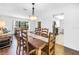 Cozy dining room adjacent to the living area, featuring a chandelier and views of the outdoors at 435 Whispering Oaks Ct, Sarasota, FL 34232