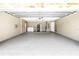 Spacious garage featuring epoxy flooring, laundry area, and utility connections at 435 Whispering Oaks Ct, Sarasota, FL 34232