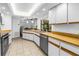Bright kitchen with white cabinets, wood countertops, stainless steel appliances and tile floors at 435 Whispering Oaks Ct, Sarasota, FL 34232