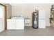 Well-lit laundry room with washer, dryer, sink, and ample storage space at 435 Whispering Oaks Ct, Sarasota, FL 34232